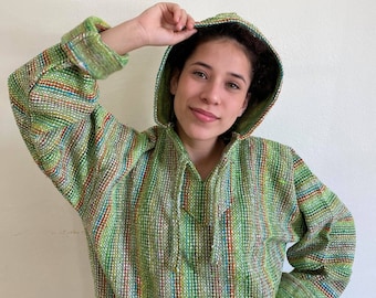 May include: A green, red, and blue striped hoodie with a drawstring hood.