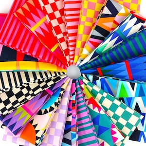 May include: A circular arrangement of folded fabric swatches featuring a variety of vibrant geometric patterns including stripes, checkers, diamonds, and triangles in a spectrum of colours such as red, yellow, blue, pink, purple, and black.