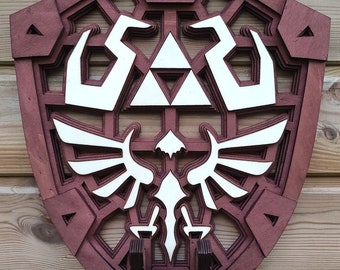 May include: A wooden shield with a red-brown stain, featuring a white Triforce symbol and a white winged design. The shield is mounted on a wooden wall.
