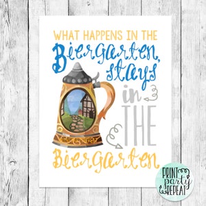 May include: A watercolor illustration of a beer stein with a scene of a Bavarian village inside. The text reads "What happens in the Biergarten, stays in the Biergarten".