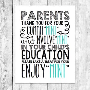 May include: A white print with black and teal text on a wooden background. The text reads "PARENTS THANK YOU FOR YOUR COMMIT 'MINT' and INVOLVE 'MINT' IN YOUR CHILD'S EDUCATION. PLEASE TAKE A TREAT FOR YOUR ENJOY 'MINT'."