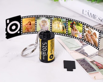 May include: A black and yellow film canister keychain with a silver key ring. The canister has the text "35mm Film for Color Prints 52013 EXP" printed on it. The keychain is hanging from a film strip with photos.