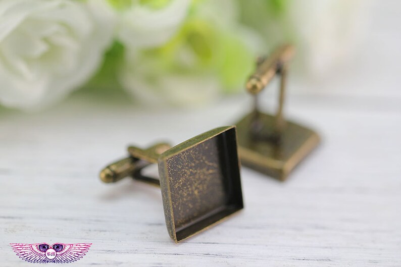 May include: A pair of antique gold cufflinks with square glass inserts. The cufflinks have a distressed finish.