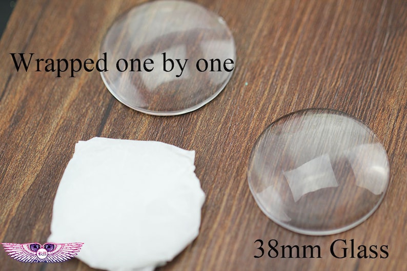 May include: Two clear glass circles, one measuring 38 mm in diameter, on a wooden surface. The text "Wrapped one by one" and "38mm Glass" are visible in the image.