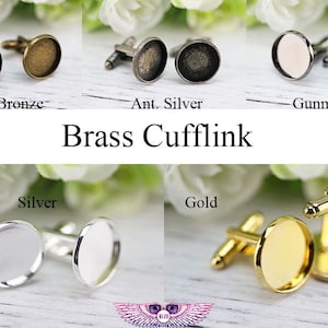 May include: Brass cufflinks in antique bronze, antique silver, gunmetal, silver, and gold finishes. The cufflinks have a round, flat surface.