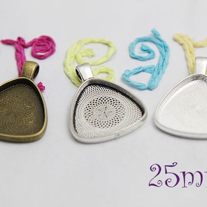 May include: Three triangle-shaped pendant trays, 25mm in size, with a silver, antique bronze, and clear finish. The trays have a decorative pattern on the inside.