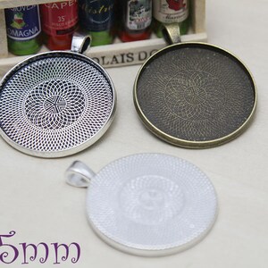 May include: Three round pendant trays in silver and bronze tones, each with a decorative patterned interior. The trays are approximately 35mm in diameter, perfect for crafting custom jewelry. The trays have a loop for attaching a chain or cord.