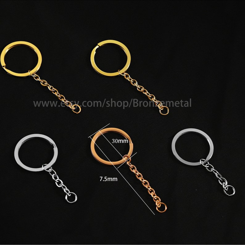May include: Three keychains with different colored rings and chains. The keychain on the left has a silver ring and chain. The keychain in the middle has a gold ring and chain. The keychain on the right has a silver ring and chain. The keychain in the middle has a 30mm ring and a 7.5mm chain.