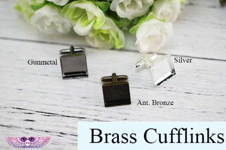 May include: Four pairs of brass cufflinks in different finishes: gunmetal, silver, antique bronze, and brass. Each pair features a square-shaped glass insert.