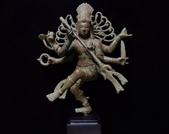 May include: A bronze statue of a Hindu deity with multiple arms, dancing in a dynamic pose. The statue is on a black wooden base.