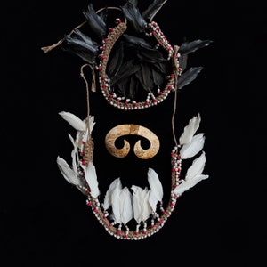 May include: A handmade wooden sign displaying the word "Welcome" in a whimsical font. It has a distressed white backdrop and a dark brown border. A small heart decoration is affixed at the base.