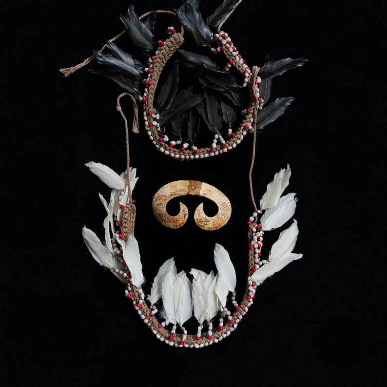 May include: A handmade wooden sign displaying the word "Welcome" in a whimsical font. It has a distressed white backdrop and a dark brown border. A small heart decoration is affixed at the base.