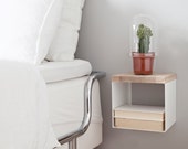 Shelf for bedroom, hall or livingroom. Made of solid whiteoiled Oak with white powdercoated steel base.