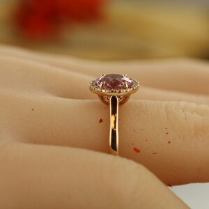 Natural pink morganite surrounded by a sparkling halo of vibrant and brilliant cut natural diamonds in 14k rose gold