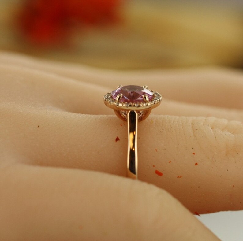 Natural pink morganite surrounded by a sparkling halo of vibrant and brilliant cut natural diamonds in 14k rose gold
