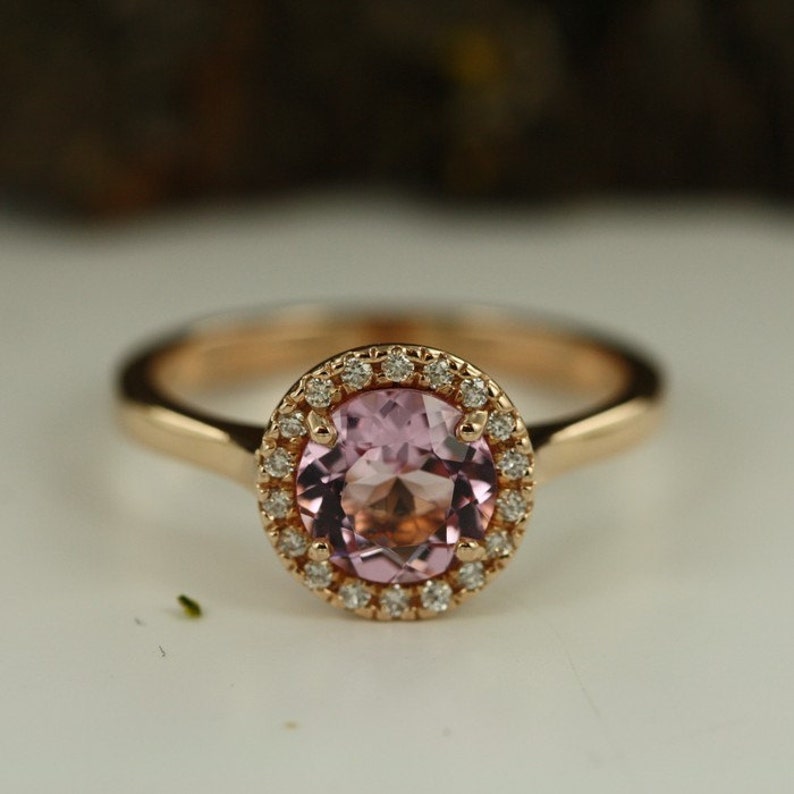 Natural pink morganite surrounded by a sparkling halo of vibrant and brilliant cut natural diamonds in 14k rose gold