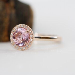 Natural pink morganite surrounded by a sparkling halo of vibrant and brilliant cut natural diamonds in 14k rose gold