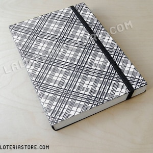 May include: A black and white plaid notebook with a black elastic band closure.