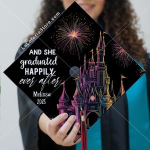 May include: Black graduation cap featuring a colourful castle design and fireworks. The text reads "AND SHE graduated HAPPILY ever after", with the name "Melissa" and the year "2025".