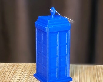 May include: A blue 3D printed TARDIS ornament with a silver loop for hanging.