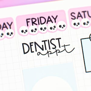 May include: A planner page with pink and white skull stickers marking the days of the week. The word "DENTIST appt" is written in black ink. A light blue square with a skull sticker is in the center.