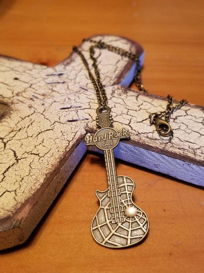 A bronze hard rock cafe guitar pendant necklace guitar