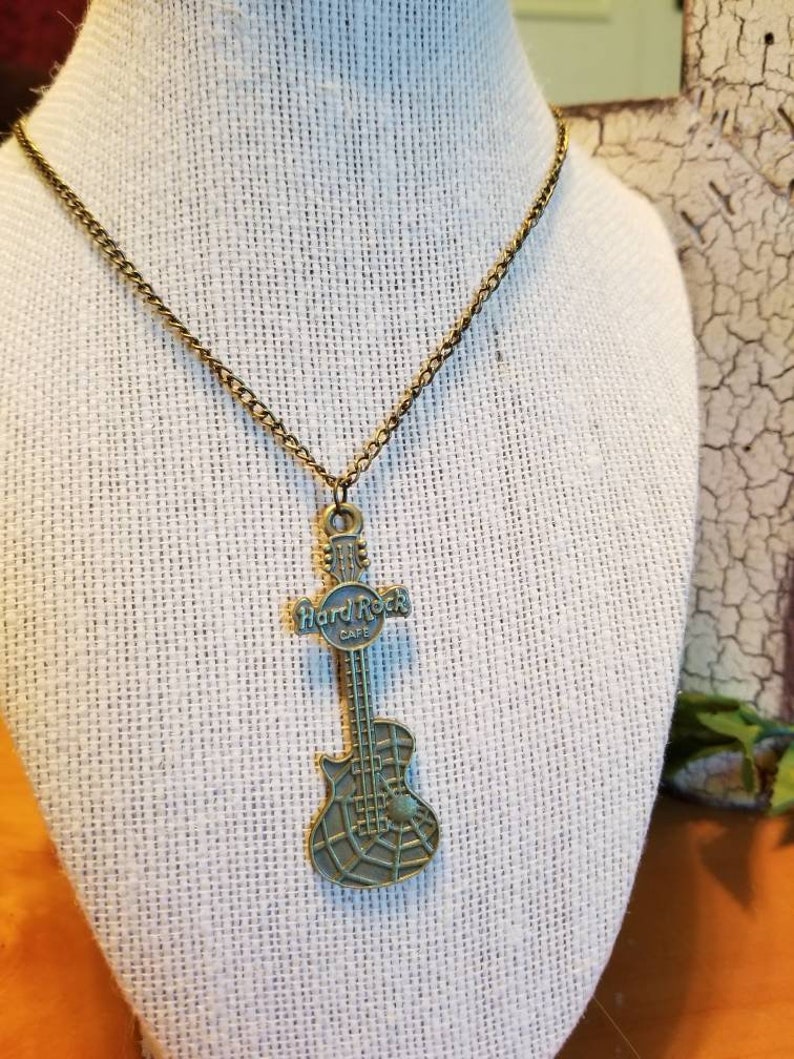 A bronze hard rock cafe guitar pendant necklace guitar