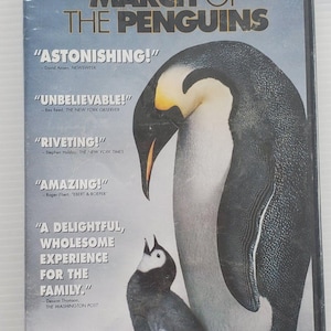 May include: DVD of the documentary "March of the Penguins" featuring a large penguin and a smaller chick. The cover includes quotes like "Astonishing!" and "Amazing!" and the text "As Told by Morgan Freeman."