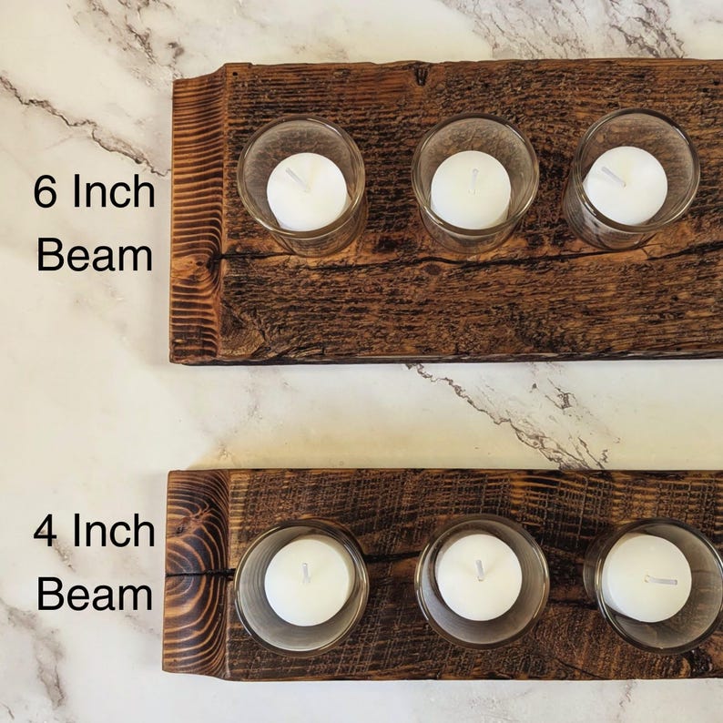 May include: Two rustic wooden candle holders, one 6 inches wide and the other 4 inches wide, each with three clear glass votive holders. Each votive holds a white candle. The wood has a natural, distressed finish.