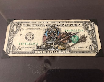 Sand people painted on a dollar bill