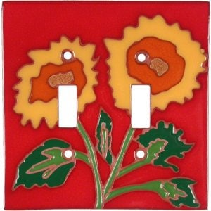 May include: Double light switch cover with a red background and two yellow sunflowers with orange centers and green leaves.