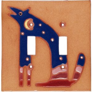 May include: A ceramic light switch cover with a blue wolf design. The wolf is howling at the moon and has stars on its body. The background is a light brown color.