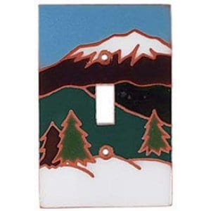 May include: A ceramic light switch cover with a mountain scene. The cover features a snowy mountain peak, green trees, and a brown and white landscape.