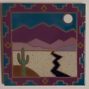 May include: A ceramic tile with a southwestern desert scene. The tile features a purple and blue sky with a white moon, a cactus, and a winding river in the foreground. The tile is framed with a purple and teal border.