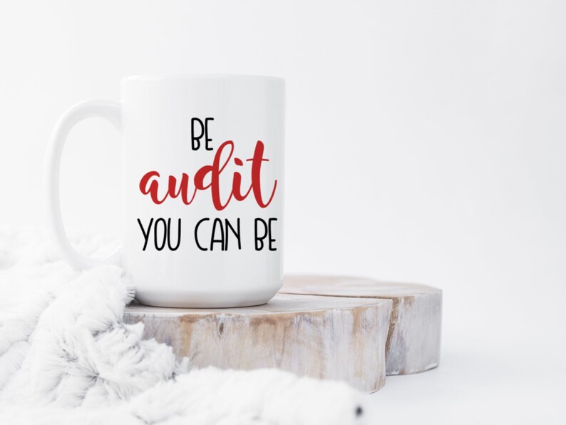 Funny audit mug. It says, "be audit you can be" with the word audit in red.