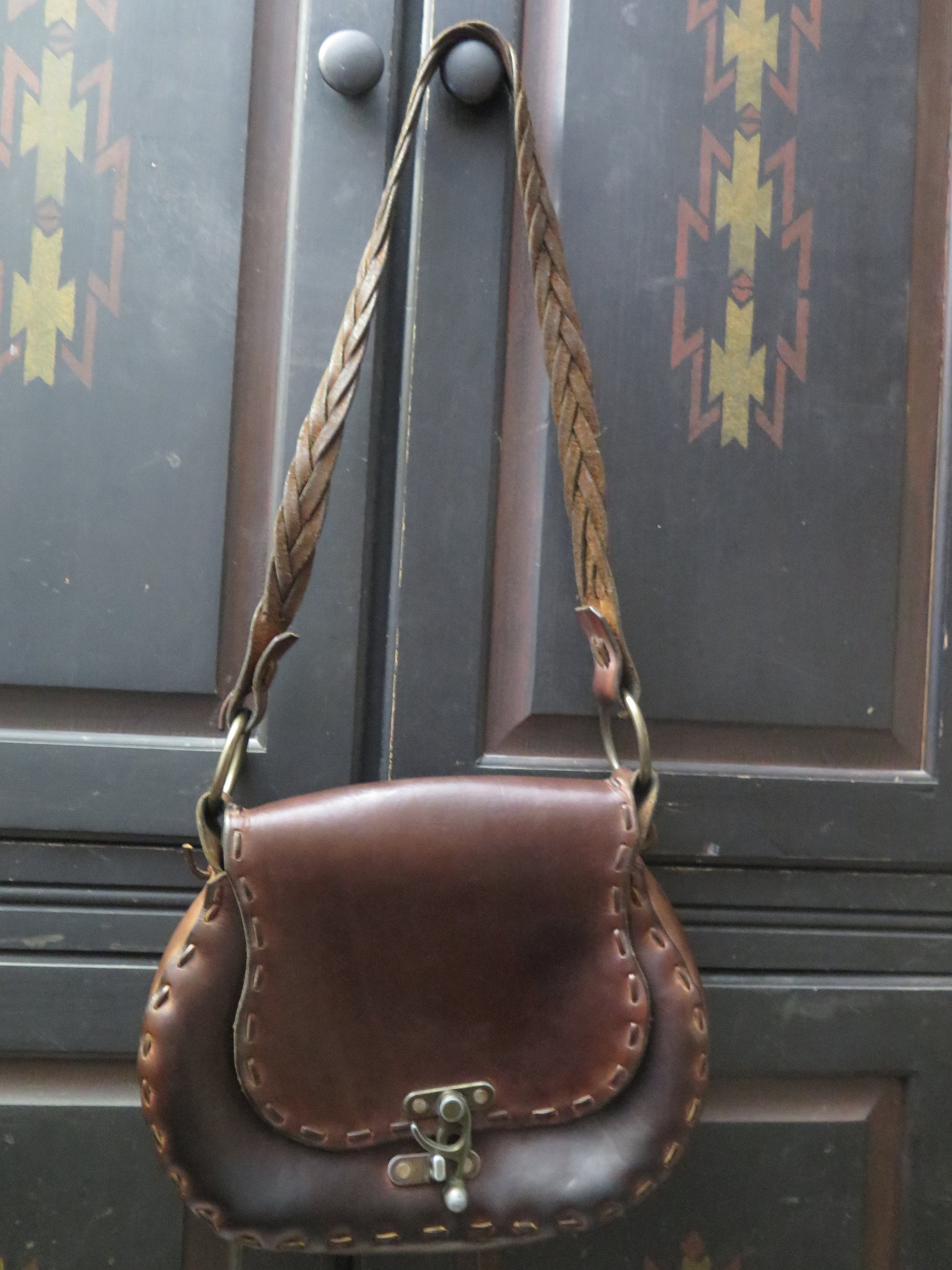 vintage leather handbag with metal latch