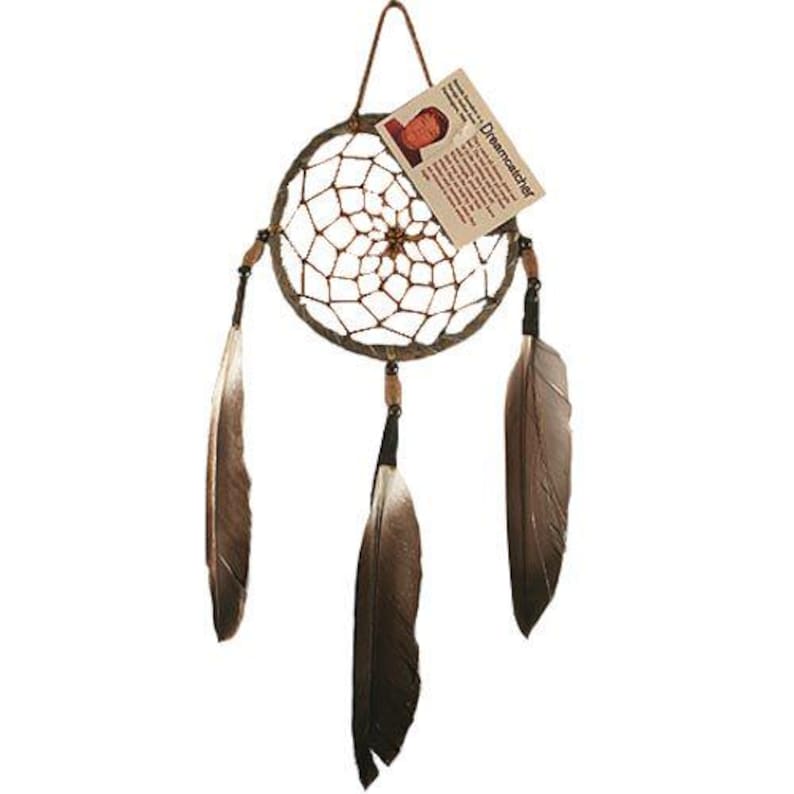 May include: A brown dreamcatcher with three brown feathers hanging from it. The dreamcatcher has a beaded border and a small tag that reads "Dreamcatcher".