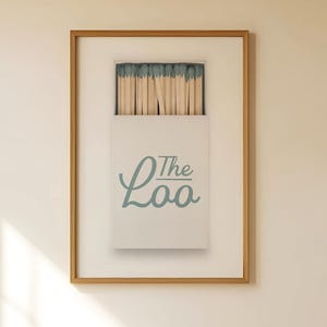 Bathroom Matchbook Print with The Loo written in cursive on the matchbook