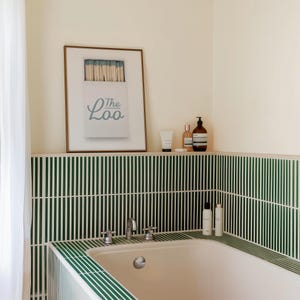 Bathroom Matchbook Print with The Loo written in cursive on the matchbook