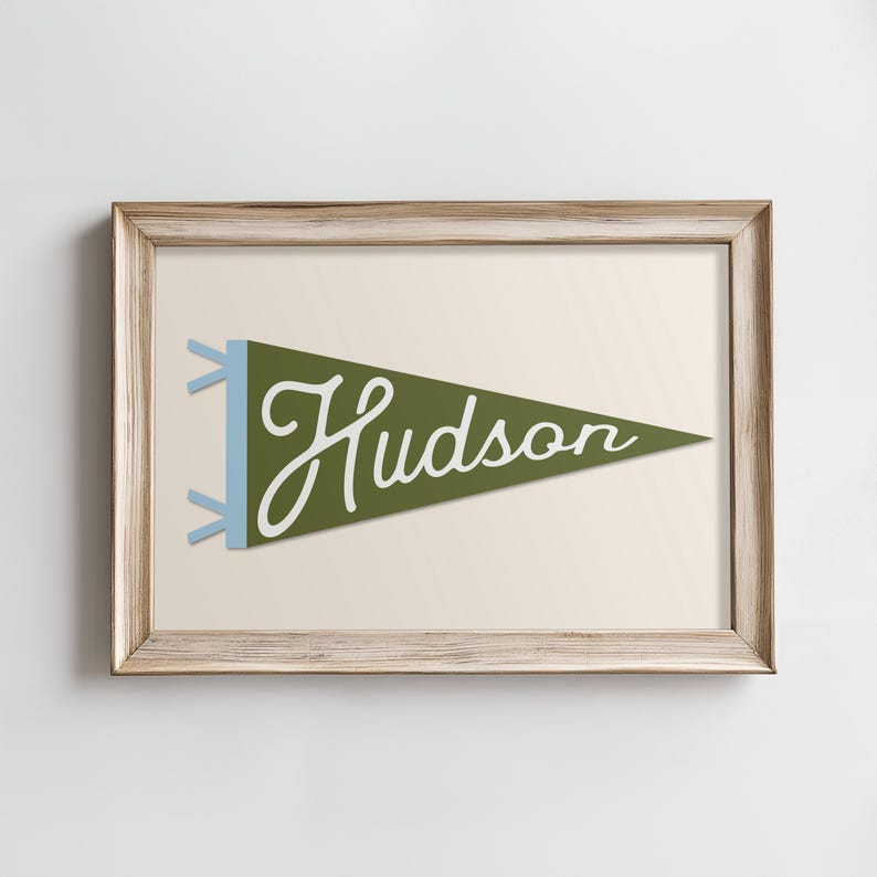 May include: A framed print of a green pennant with the word "Hudson" written in white cursive.
