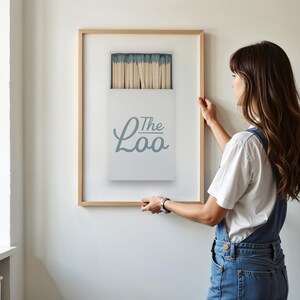 Bathroom Matchbook Print with The Loo written in cursive on the matchbook