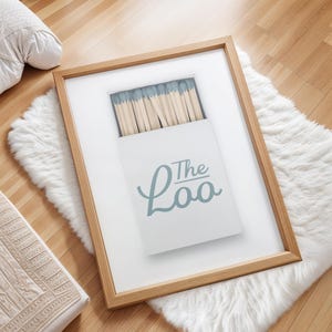 Bathroom Matchbook Print with The Loo written in cursive on the matchbook