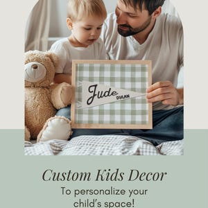 May include: A personalized framed print with the name "Jude" and "Dylan" on a green and white checkered background. The print is held by a man and a child, with a teddy bear nearby. The image also includes the text "Custom Kids Decor".