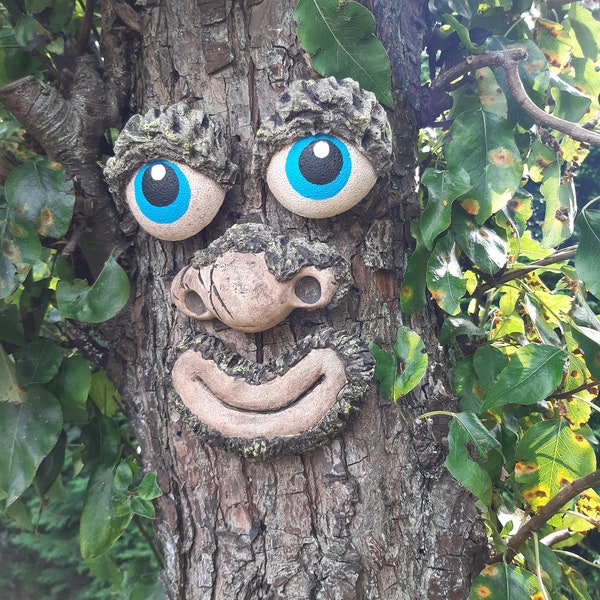 Faces for trees in the garden.  Funny statue, sculpture faces for Christmas gifts for gardeners.  Smiling happy stone faces for hanging.