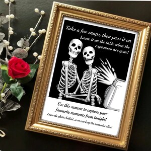 May include: A black and white illustration of two skeletons taking a photo with a vintage camera. The text reads "Take a few snaps, then pass it on. Leave it on the table when the exposures are gone! Use this camera to capture your favorite moments from tonight! Leave the photos behind, so we can keep the memories alive!"