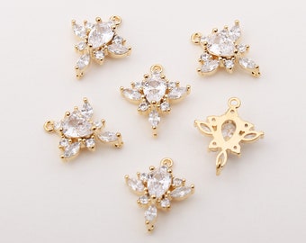 May include: Six gold-tone pendant charms with clear crystal accents. Each charm features a teardrop-shaped crystal surrounded by smaller crystals.