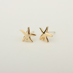 May include: A pair of gold-tone starfish stud earrings. The earrings are small and delicate, and they would make a great gift for someone who loves the ocean.