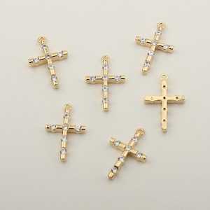 Puede incluir: Seis dijes de cruz de tono dorado con acentos de diamantes de imitación transparentes. Los dijes son perfectos para hacer joyas o agregar un toque de brillo a las manualidades.
