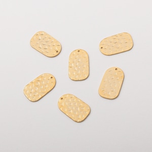 May include: Six gold-toned metal oval-shaped charms with a hammered texture. Each charm has two small holes at the top.