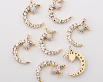 May include: Seven gold crescent moon charms with clear opal stones and clear cubic zirconia accents.